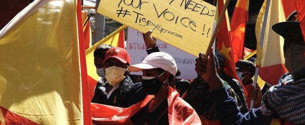 Protesters marching against the conflict in Tigray hold placards with the hashtag #TigrayGenocide in New York City on March 25, 2021. (Source: Reuters/John Lamparski/SIPA USA)