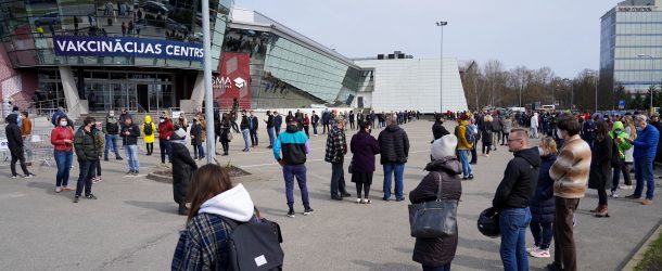 People queue up outside a mass vaccination centre as Latvia opens walk in coronavirus disease (COVID-19) vaccination scheme in Riga, Latvia, April 16, 2021.