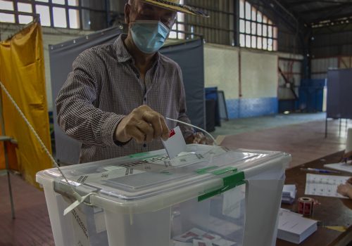 A Chilean man places his vote in the ballot box during the second round of the presidential elections in Maipú, Chile on December 19, 2021.