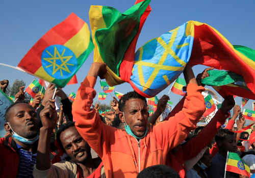 A man holds the Ethiopian national flag in Addis Ababa’s Meskel Square during a pro-government rally to denounce what the organizers say is the Tigray People’s Liberation Front (TPLF) and Western countries’ interference in internal affairs of the country, November 7, 2021.