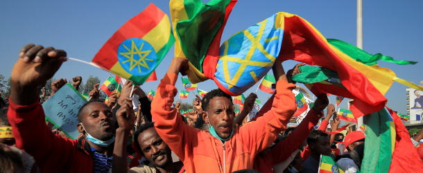 A man holds the Ethiopian national flag in Addis Ababa’s Meskel Square during a pro-government rally to denounce what the organizers say is the Tigray People’s Liberation Front (TPLF) and Western countries’ interference in internal affairs of the country, November 7, 2021.