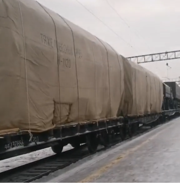 Screenshot of video showing Iskander-M launch vehicles covered in tarp at an unspecified location.