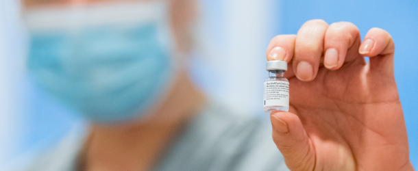 A nurse holds a vial of Pfizer-BioNTech Covid-19 vaccine doses in n Råå, Sweden on December 27, 2020.