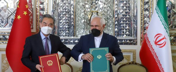 Iranian Foreign Minister Mohammad Javad Zarif and Chinese Foreign Minister Wang Yi bump elbows during the signing ceremony of a 25-year cooperation agreement in Tehran, March 27, 2021.