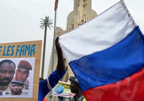 Malians holds a Russian flag and a photograph with an image of coup leader Colonel Assimi Goita during a pro-Malian Armed Forces (FAMA) demonstration in Bamako, Mali, May 28, 2021.