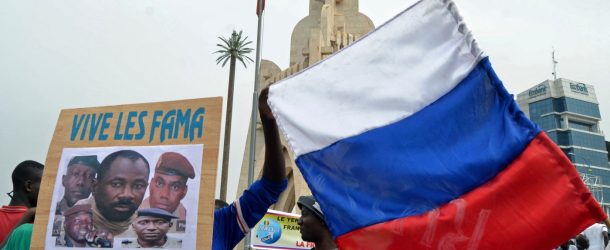 Malians holds a Russian flag and a photograph with an image of coup leader Colonel Assimi Goita during a pro-Malian Armed Forces (FAMA) demonstration in Bamako, Mali, May 28, 2021.