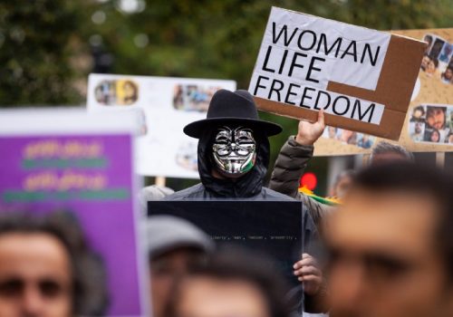 A person wearing Guy Fawkes mask, attends a solidarity protest for Mahsa Amini in Washington DC on October 1, 2022.
