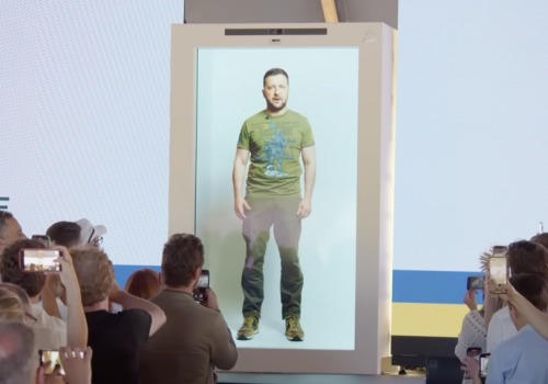 Ukrainian President Zelenskyy speaks at a conference via a hologram. A behind-the-scenes video documenting the recording of the hologram was used in false narratives claiming the president had fled the country.