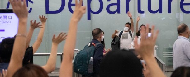 A family says farewell to their friends and families before departing for the UK at Hong Kong International Airport, July 18, 2021.