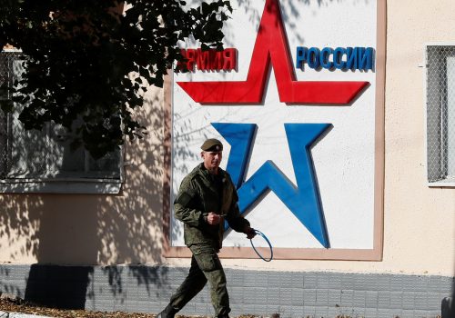 A Russian serviceman walks past the Operational Group of Russian Forces headquarters in Tiraspol, in Moldova's self-proclaimed separatist Transnistria, November 3, 2021. The banner reads "Army of Russia." REUTERS/Gleb Garanich