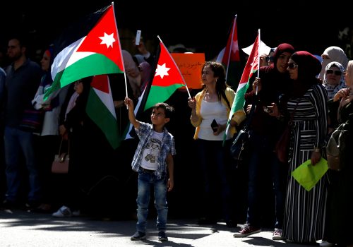 People hold Jordanian national flags as they take part in a protest during a teachers' strike in Amman, Jordan, October 3, 2019.