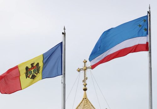 Flags of Moldova and the autonomous region of Gagauzia fly next to a church in Comrat, the capital of the autonomous region of Gagauzia, Moldova March 2, 2023. REUTERS/Vladislav Culiomza