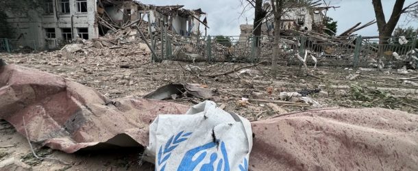 Banner: A damaged canvas sign featuring the logo for the United Nations High Commissioner for Refugees (UNCHR) appears among the ruins of an attack on an aid station in Zaporizhzhia Oblast, Ukraine. (Source: zoda_gov_ua/archive)