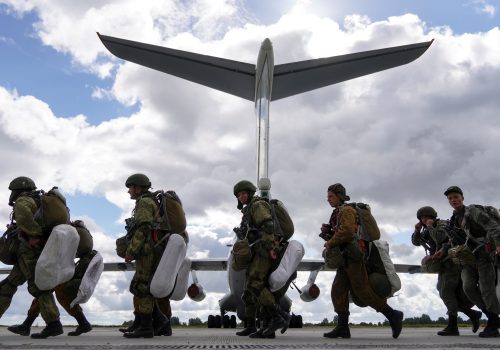 Russian paratroopers walk past an Ilyushin Il-76 transport plane during ZAPAD 21 exercises in Kaliningrad Oblast, Russia, September 13, 2021. Satellite imagery suggests that drones destroyed four 1l-76 transports at Pskov airport on August 29, 2023. (Source: Reuters/Vitaly Nevar)