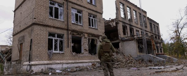 FILE PHOTO: A police officer stands in front of a damaged building, amid Russia's attack on Ukraine, in the town of Avdiivka, Donetsk region, Ukraine October 17, 2023. REUTERS/Yevhen Titov/File Photo