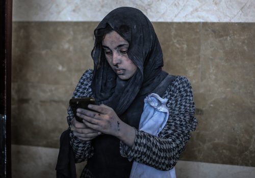 A wounded woman uses a phone at Nasser Hospital after an airstrike in the city of Khan Yunis, amid the continuing conflict between Israel and the Palestinian Hamas movement.