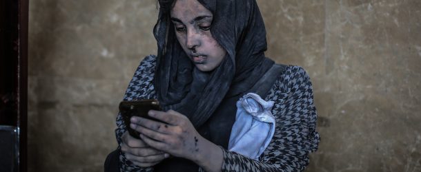 A wounded woman uses a phone at Nasser Hospital after an airstrike in the city of Khan Yunis, amid the continuing conflict between Israel and the Palestinian Hamas movement.
