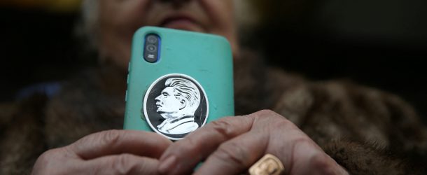 A woman holds a phone with a portrait of Soviet leader Josef Stalin on case, during an event marking the 70th anniversary of Stalin's death, in his hometown of Gori, Georgia March 5, 2023. (Source: REUTERS/Irakli Gedenidze)